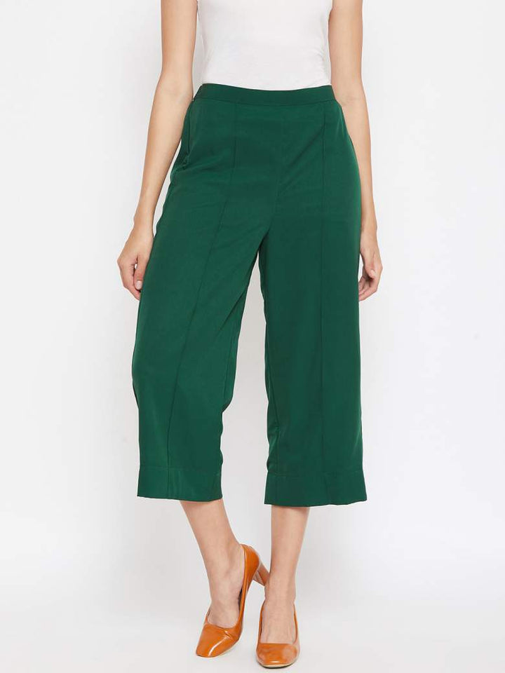 A pin tucked detailing right in the center of a bright green cropped palazzo fo women.
