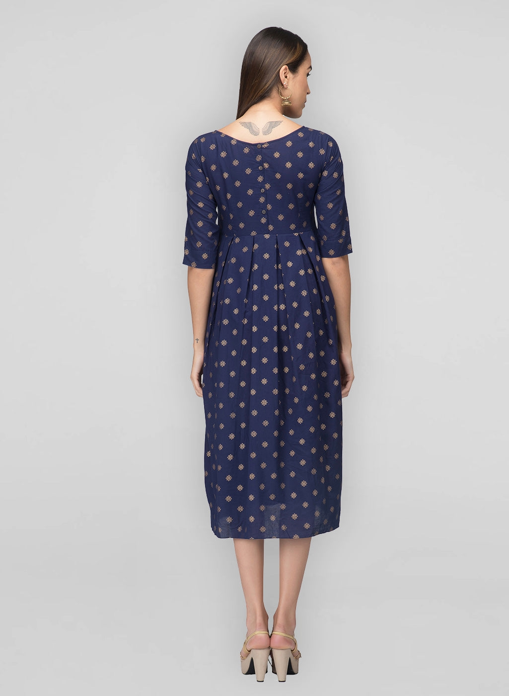 Back button detailing, boat neck, box pleats, and Indian print - east meets west in our navy box pleat dress